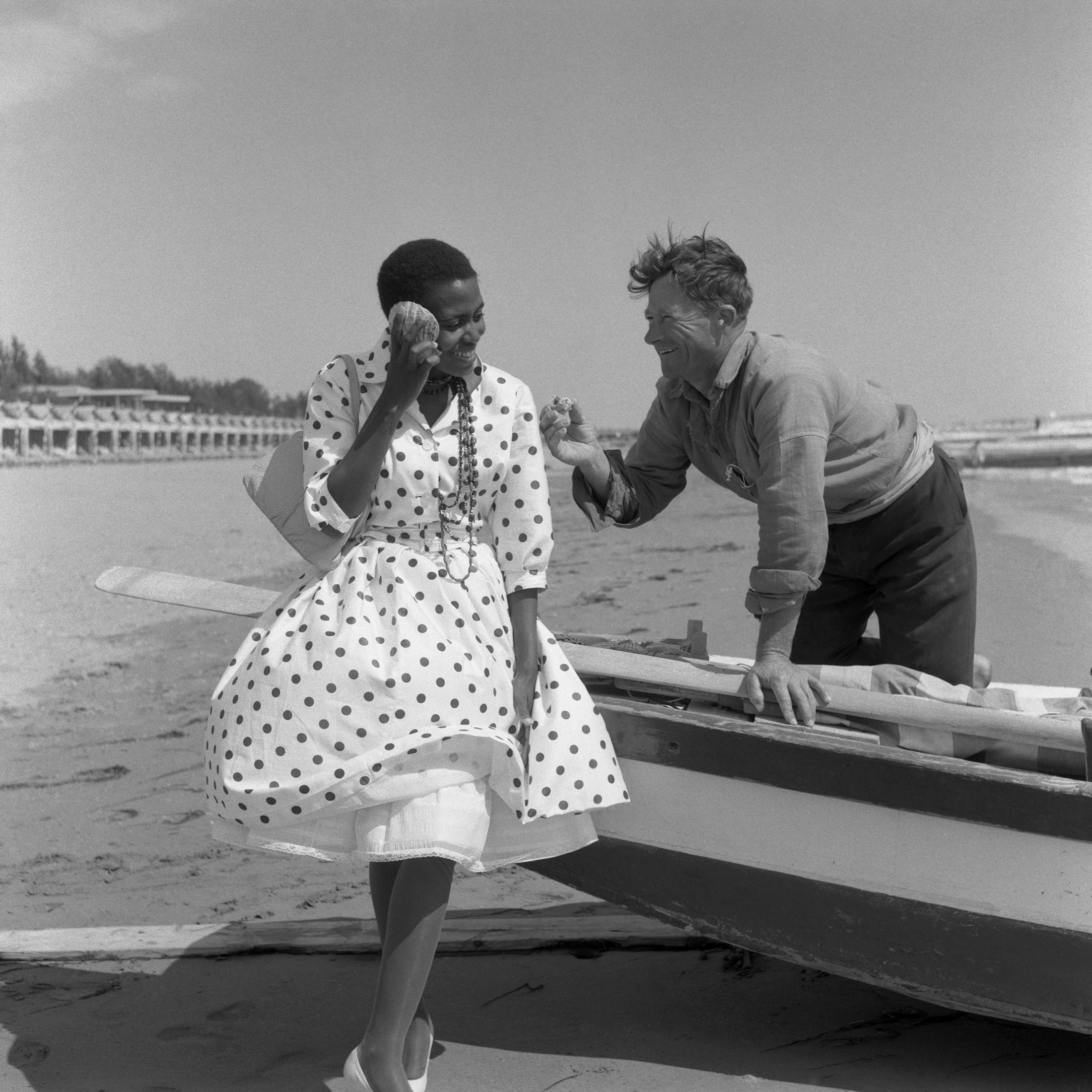 Miriam Makeba abroad for the Venice International Film Festival; here she takes in the sights at Lido Beach, Venice, Italy, 1959. Photo via Archivio Cameraphoto Epoche/Getty Images.